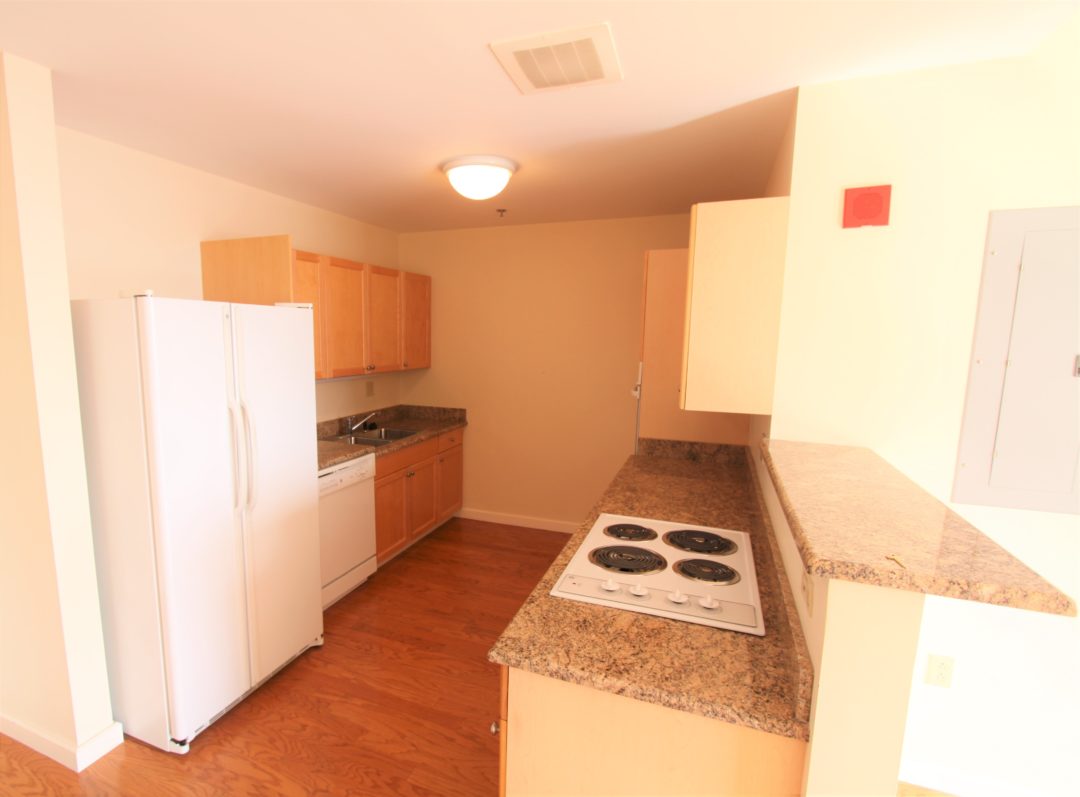 spacious kitchen with light cabinets and hard wood floors