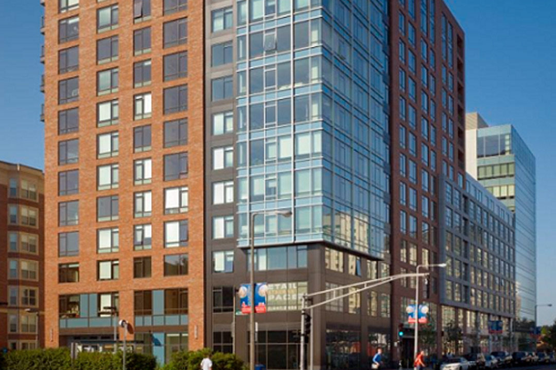 Exterior is modern, with tall glass corner and some brickwork. Corner building.