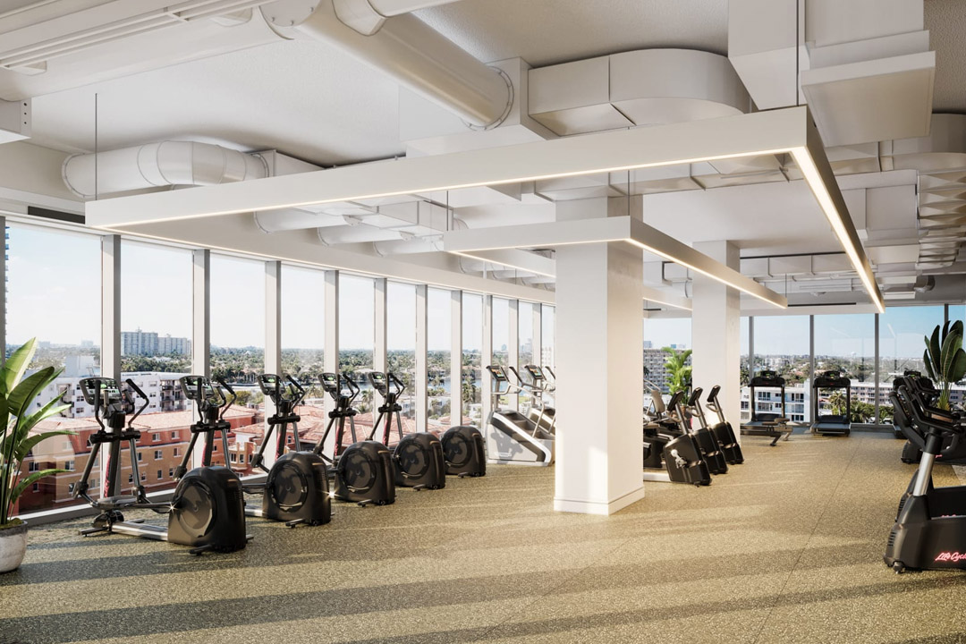 Long row of equipment facing huge windows with views.