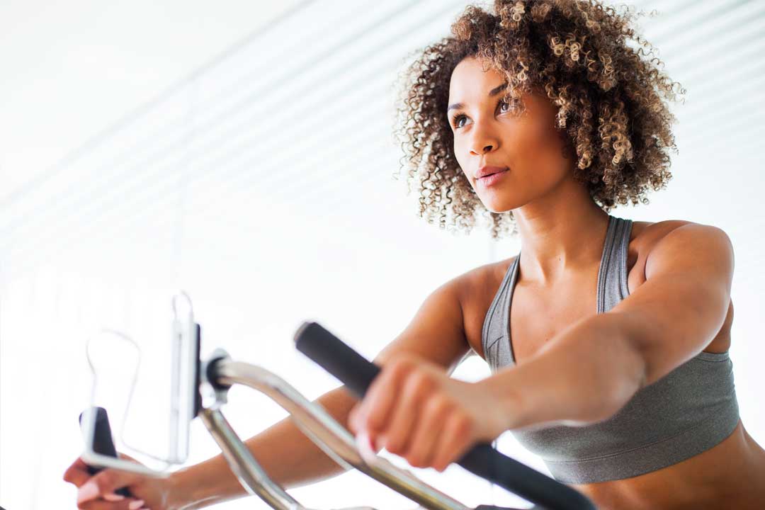 Woman on a spin bike in a fitness center
