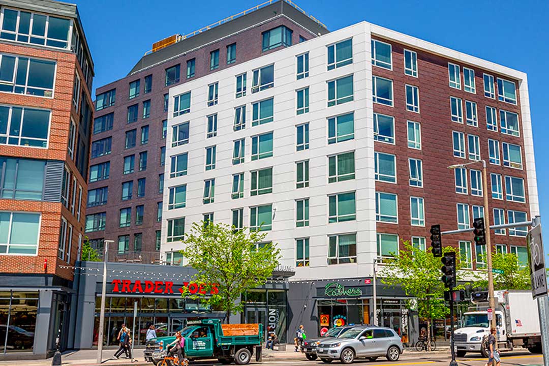 Street view showing 7 and 9 story sections with a Trader Joes next door down.