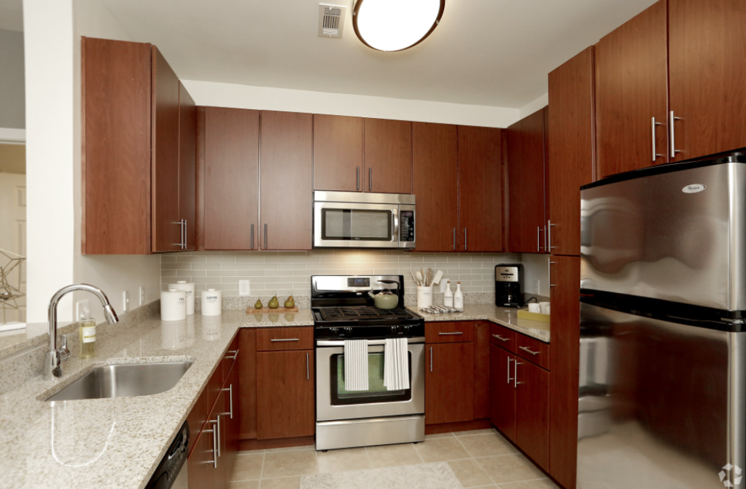 modern Kitchen with cherry cabinets and stainless steel appliances