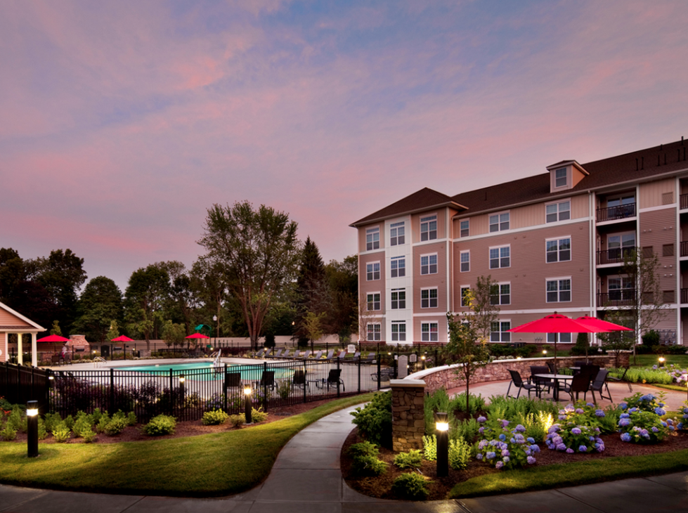 exterior area with outdoor pool and patio at sunset