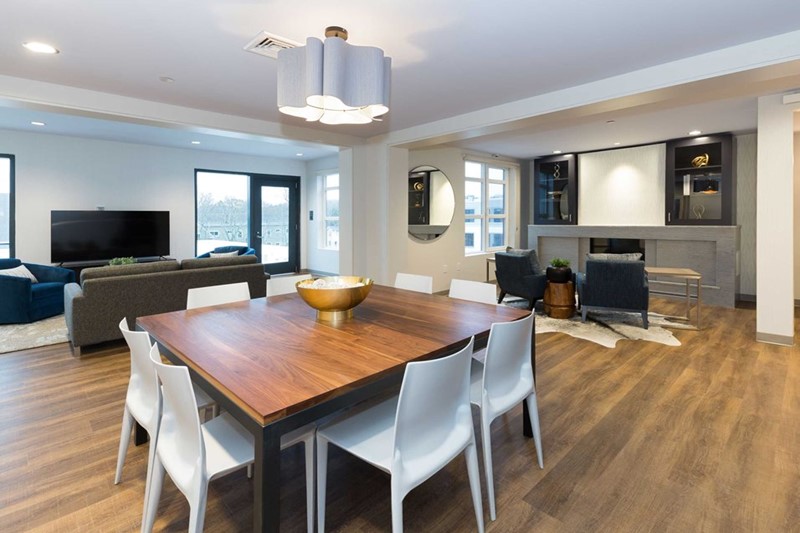 Beautiful open dining space with luxury plank flooring and modern lighting.