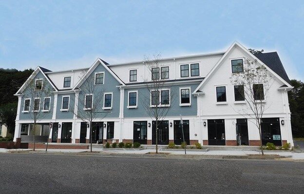 Three story building, colonial style, commercial space on first floor.