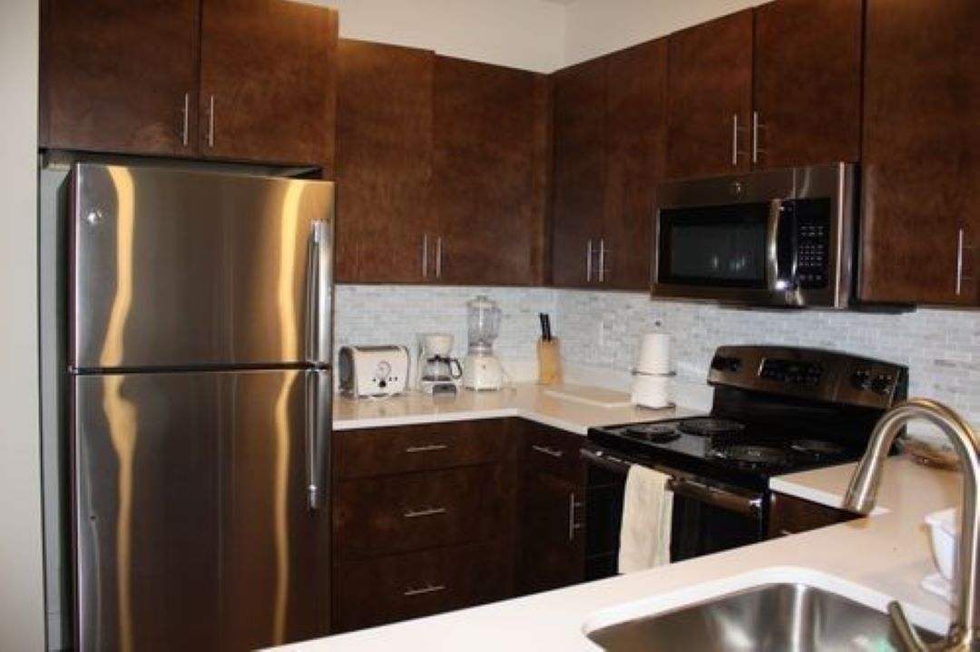 updated kitchen with dark cabinets at 450 Cambridge Street