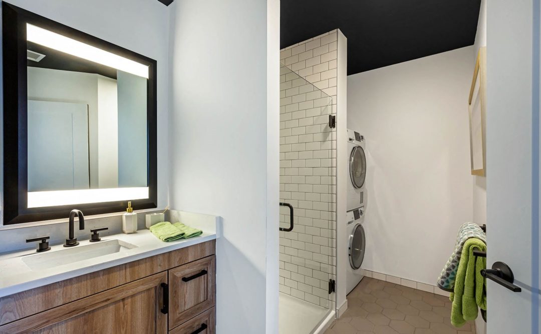 Bathroom with built in washer/dryer stacked