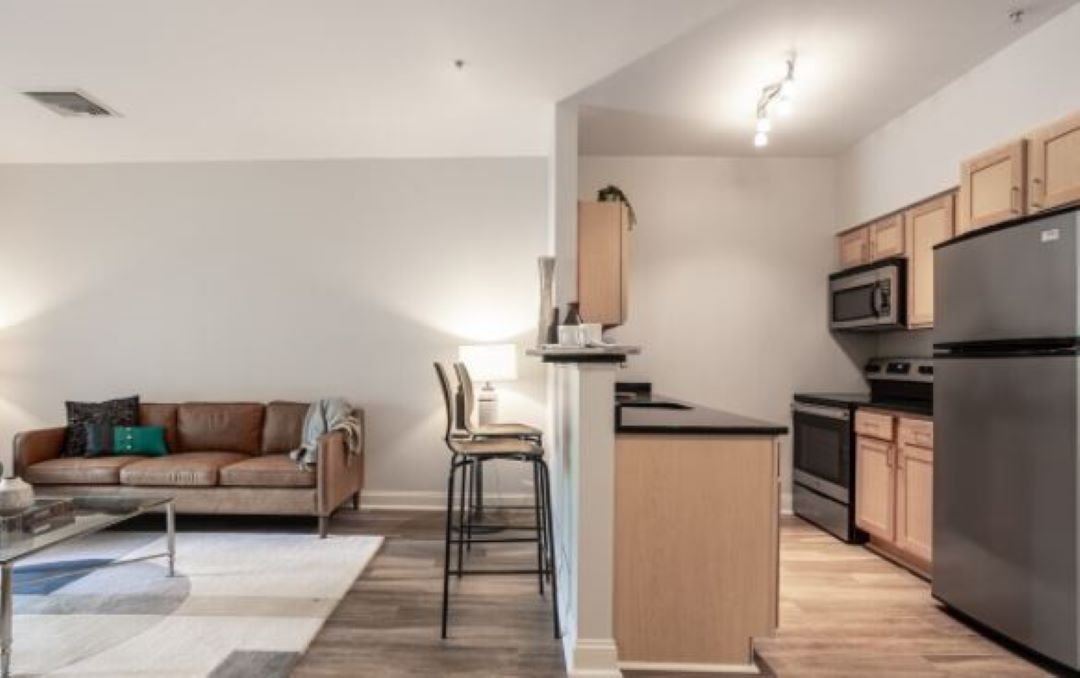 open concept living room/kitchen with hardwood floors at 100 Thompson Farm