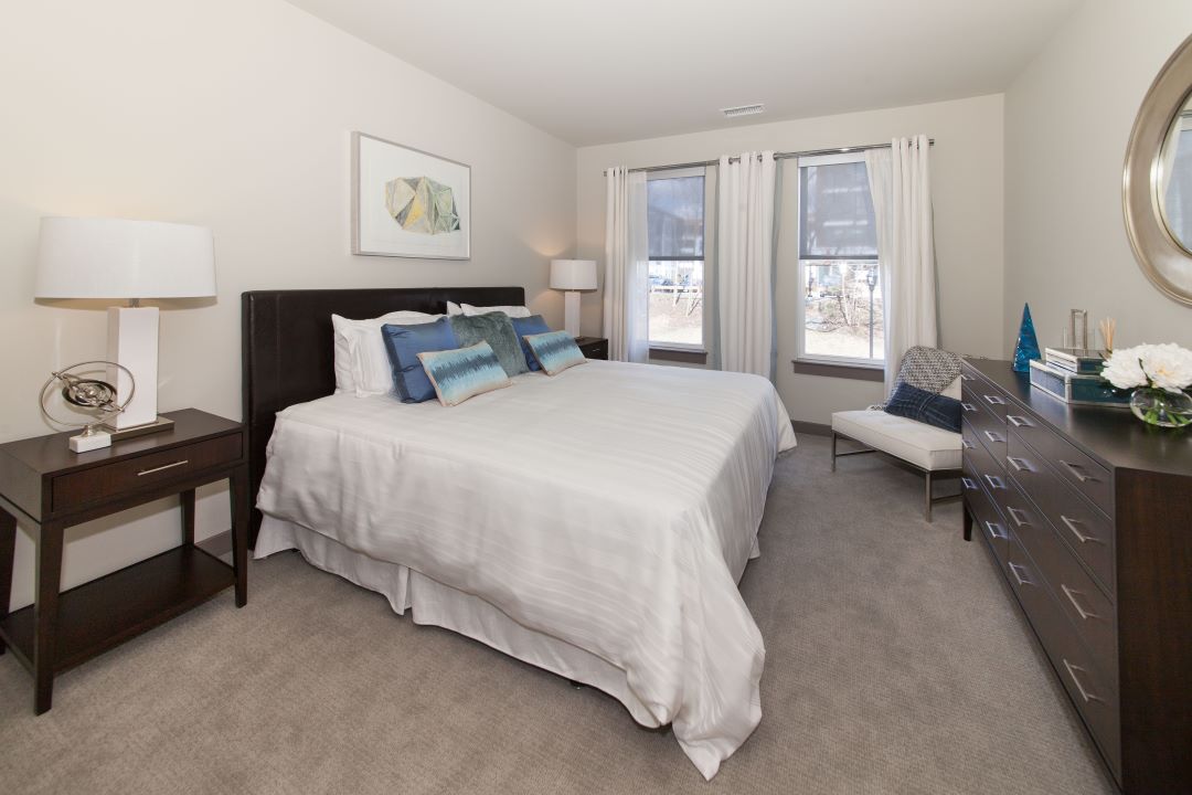 beautiful bedroom with windows and carpeting at 20 Second Avenue