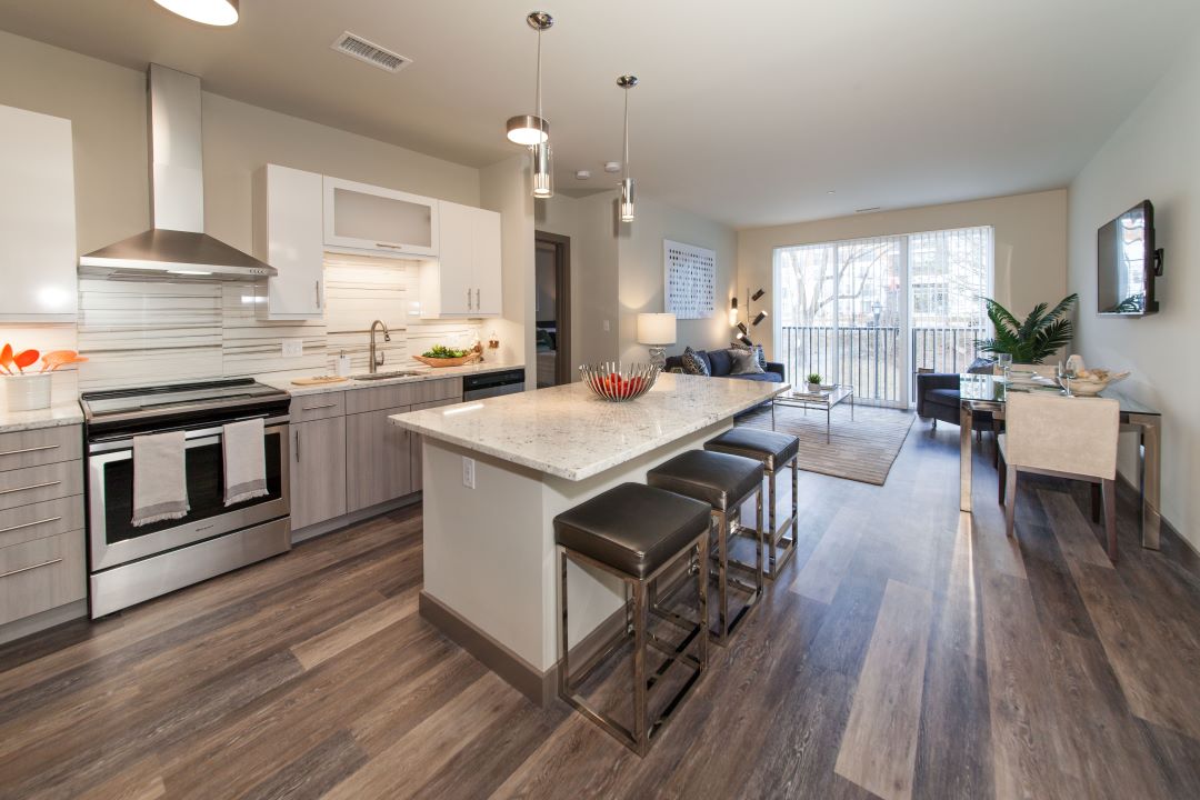 modern kitchen open to living room with hardwood floors and center island at 20 Second Avenue