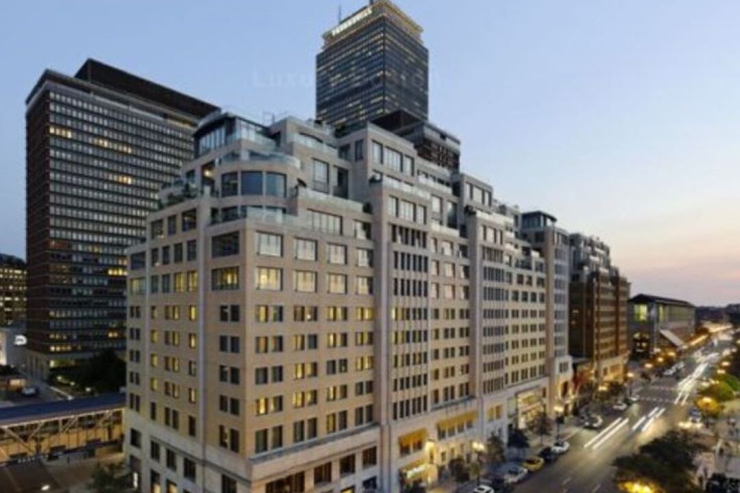 Large luxury building with Prudential Tower in background.