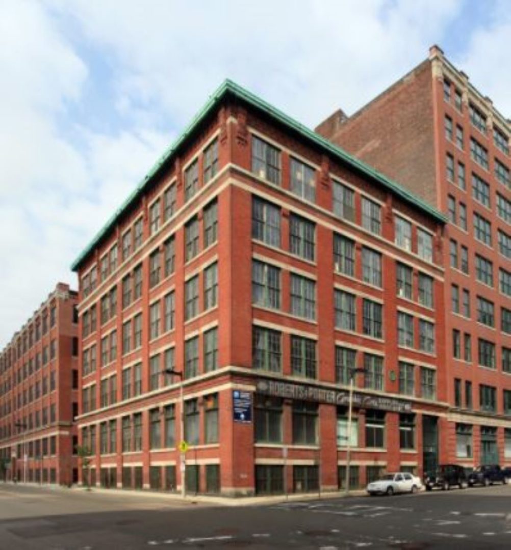 Five story brick building with lots of large windows.