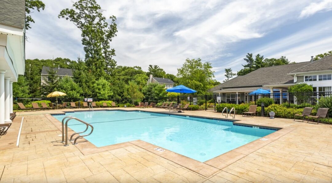 resort-style pool surrounded by lounge chairs at Prynne Hills