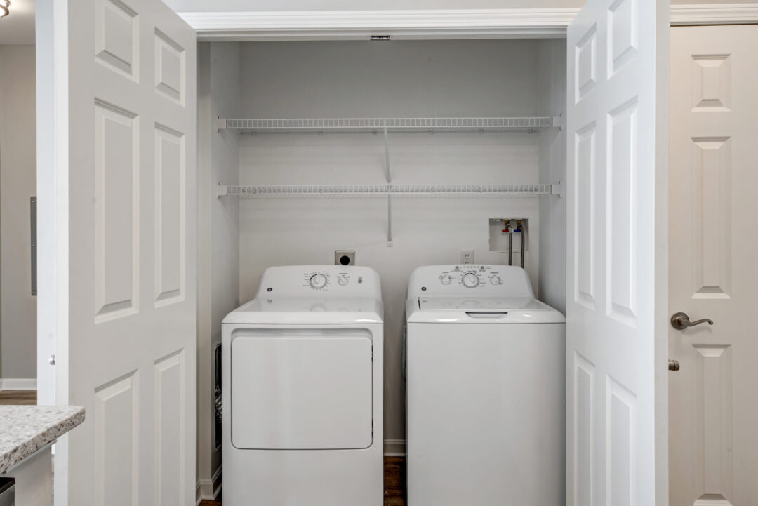 Side-by-side front-loading laundry machines integrated in a closet