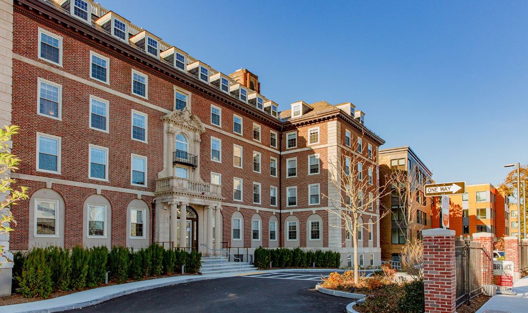 New brick apartment building, five stories.