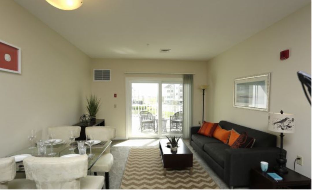 Living room leading to sliding door balcony