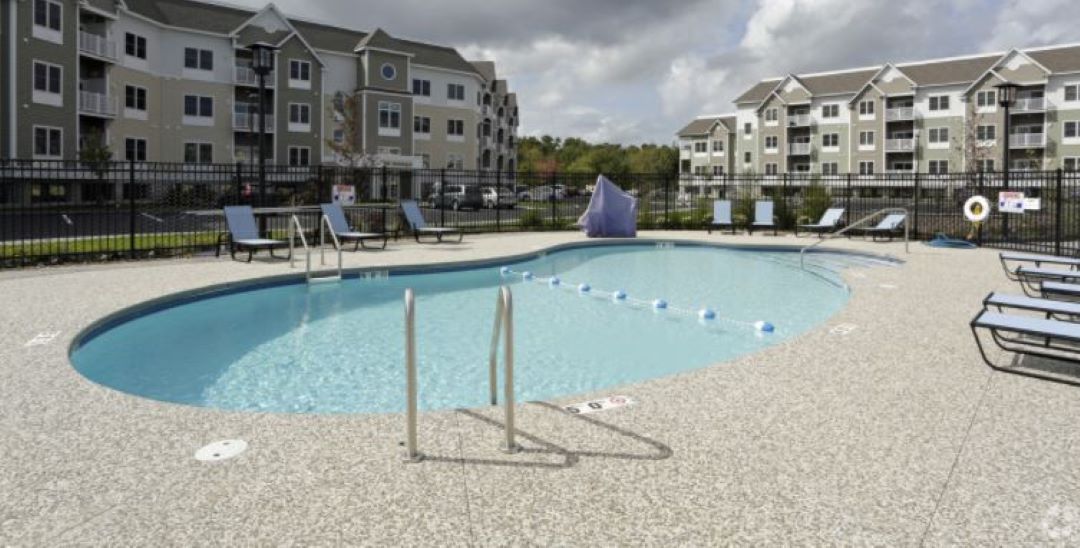 Pool and pool deck centralized in between buildings