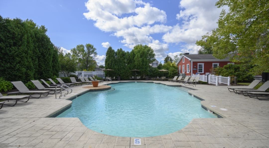 Pool and landscaped pool deck with lounge chairs