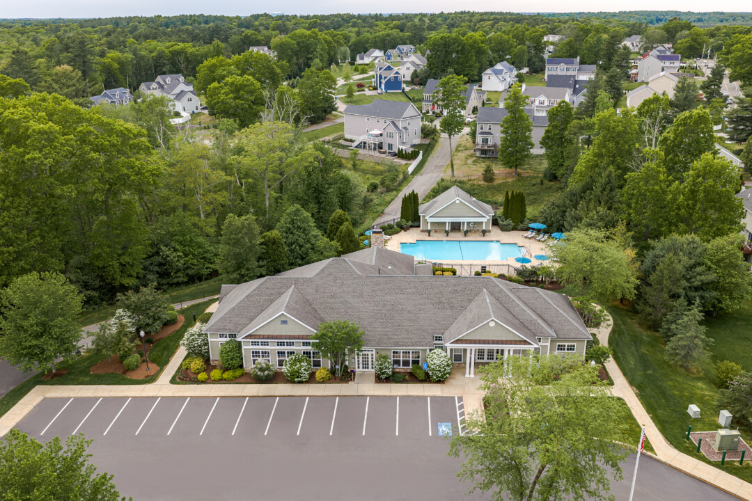 Aerial view of Prynne Hills Apartments clubhouse, swimming pool, and surrounding residential neighborhood.