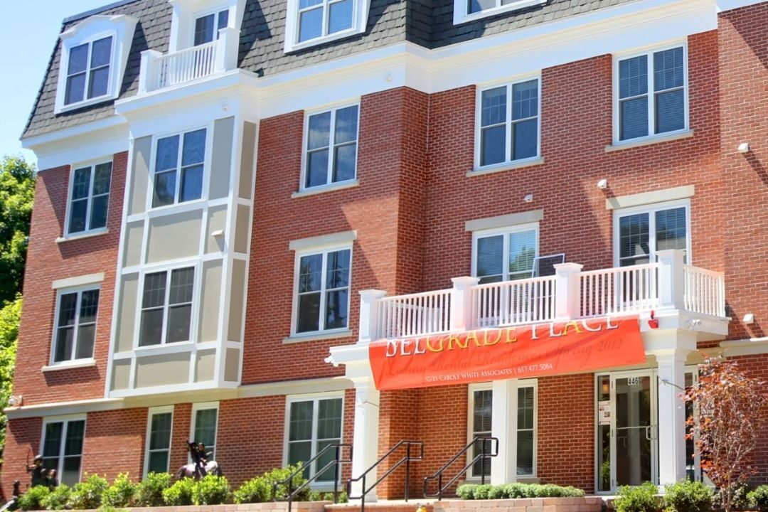 4 story brick building with covered entry.