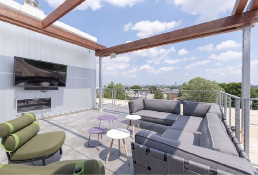spacious outdoor patio with tv and furniture at 530 Western Avenue