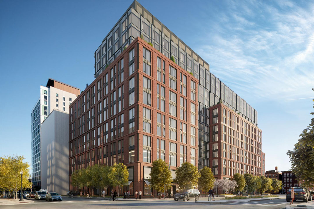 Large modern apartment building, brick and glass, corner lot, tree-lined streets, street level businesses, 10+ stories tall.