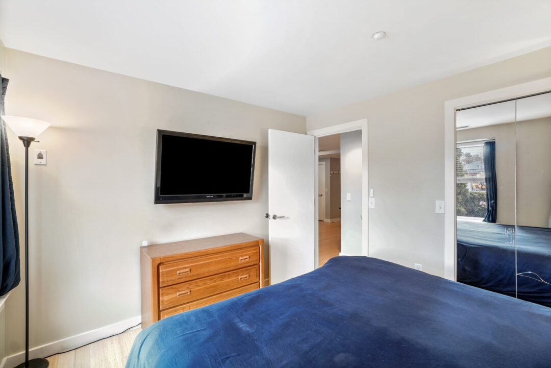 small beige bedroom with hardwood floors