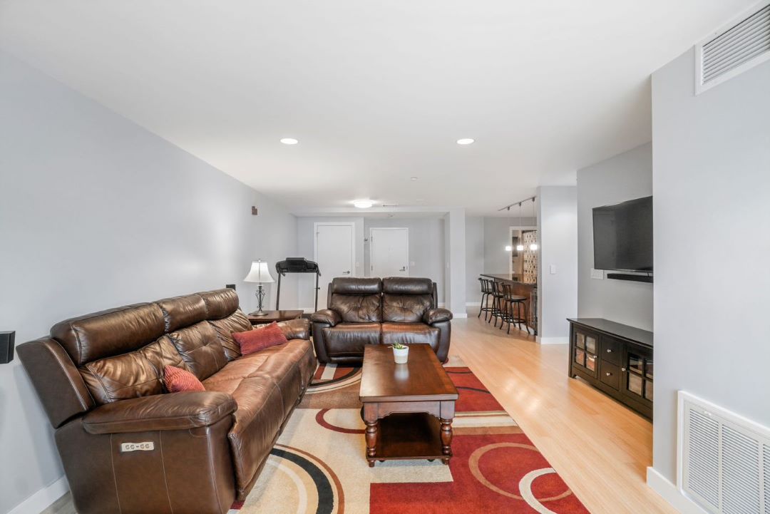 modern living room space with hard wood floors, recessed lighting and open to kitchen