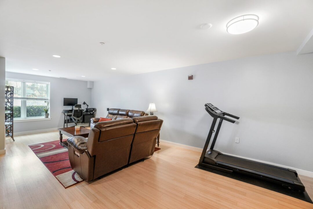 front entry of living room space with hard wood floors, recessed lighting