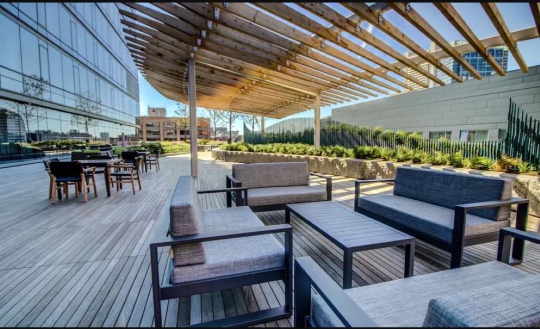large outdoor wood patio with beautiful landscape. and plenty of seating