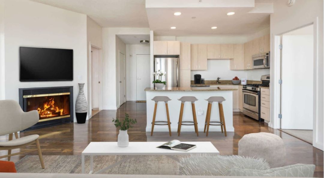 open layout living space with wood flooring and fireplace