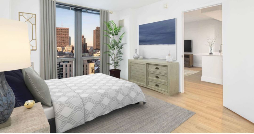 small white bedroom with wood flooring and tall window