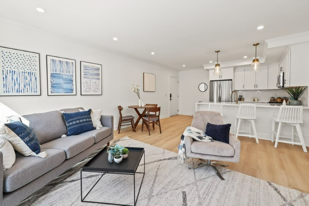 Living room with open floor plan and hardwood floors