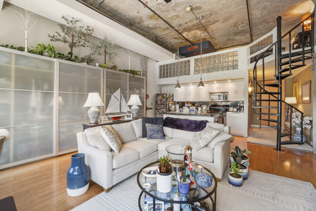 modern living room with wood floors, open layout to kitchen