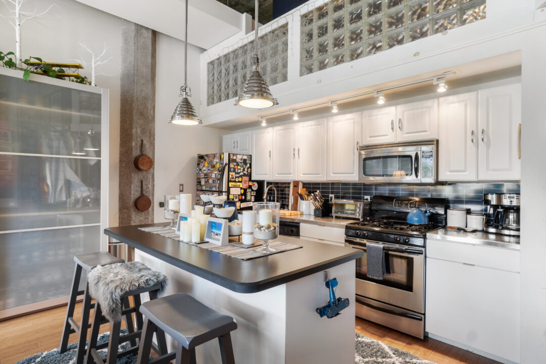 Open layout with a modern kitchen and breakfast bar.