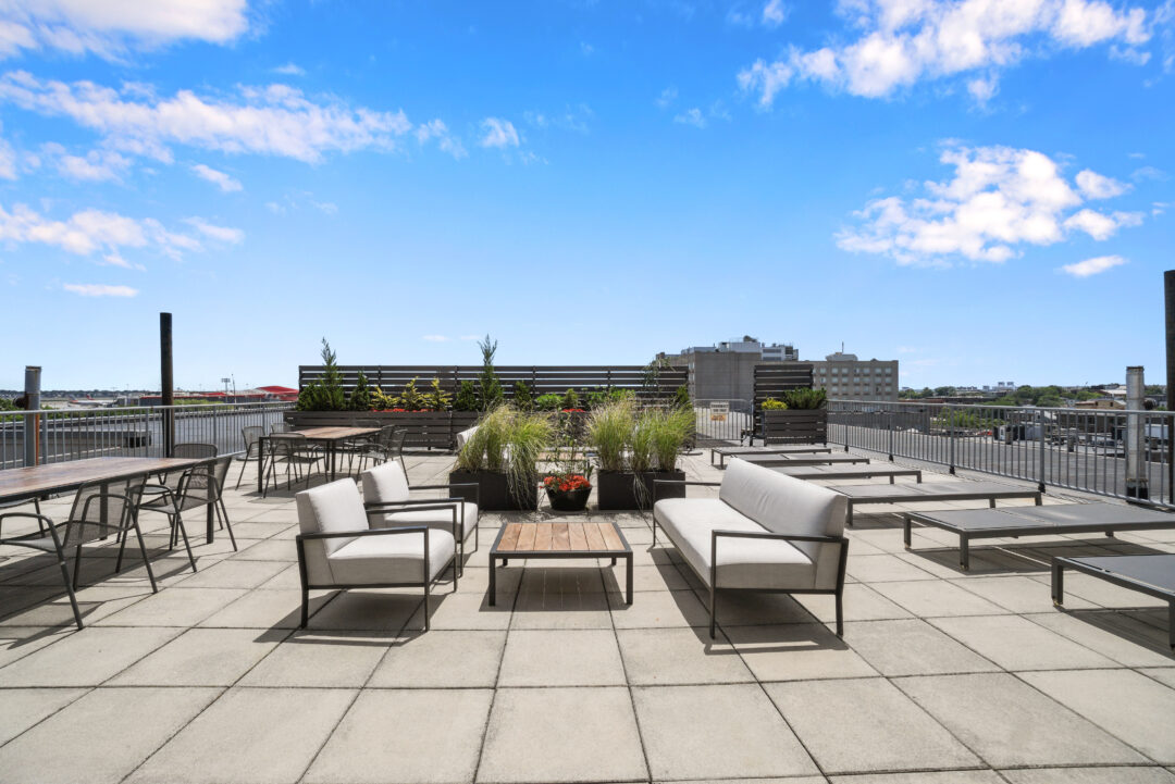 beautiful outdoor living space with roof top deck, sitting area and landscape