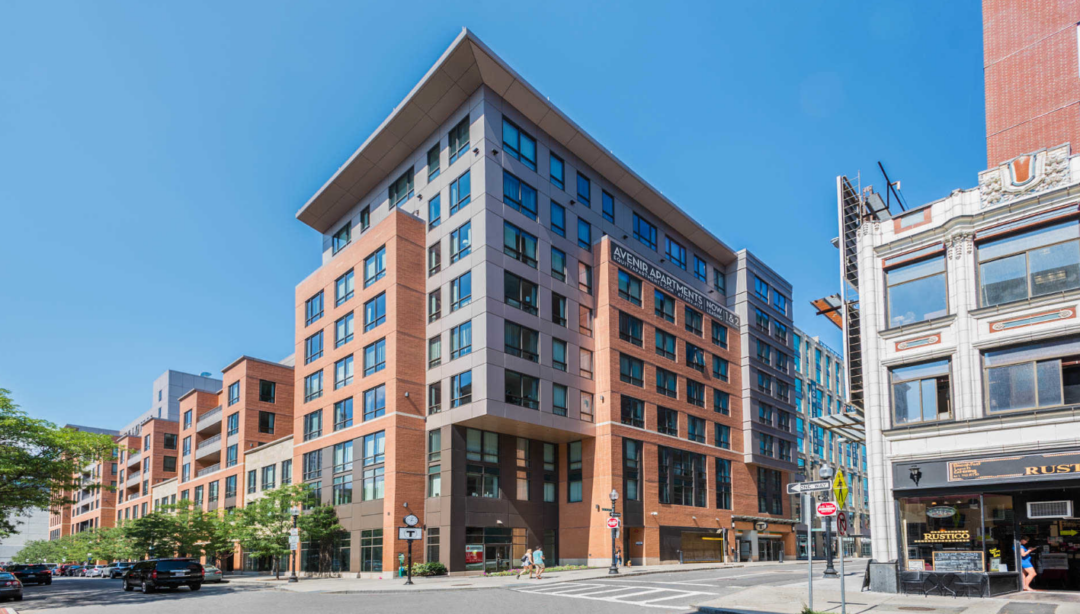 multi-story apartment building with commercial storefront on ground level