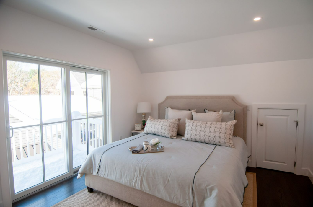 Bedroom with sliding door and hardwood floors