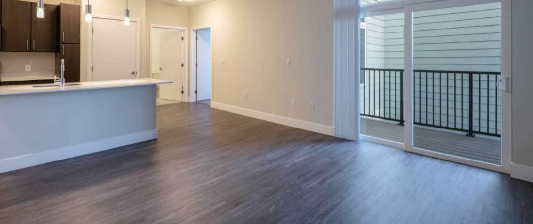 Open layout living room with balcony and hard surface flooring