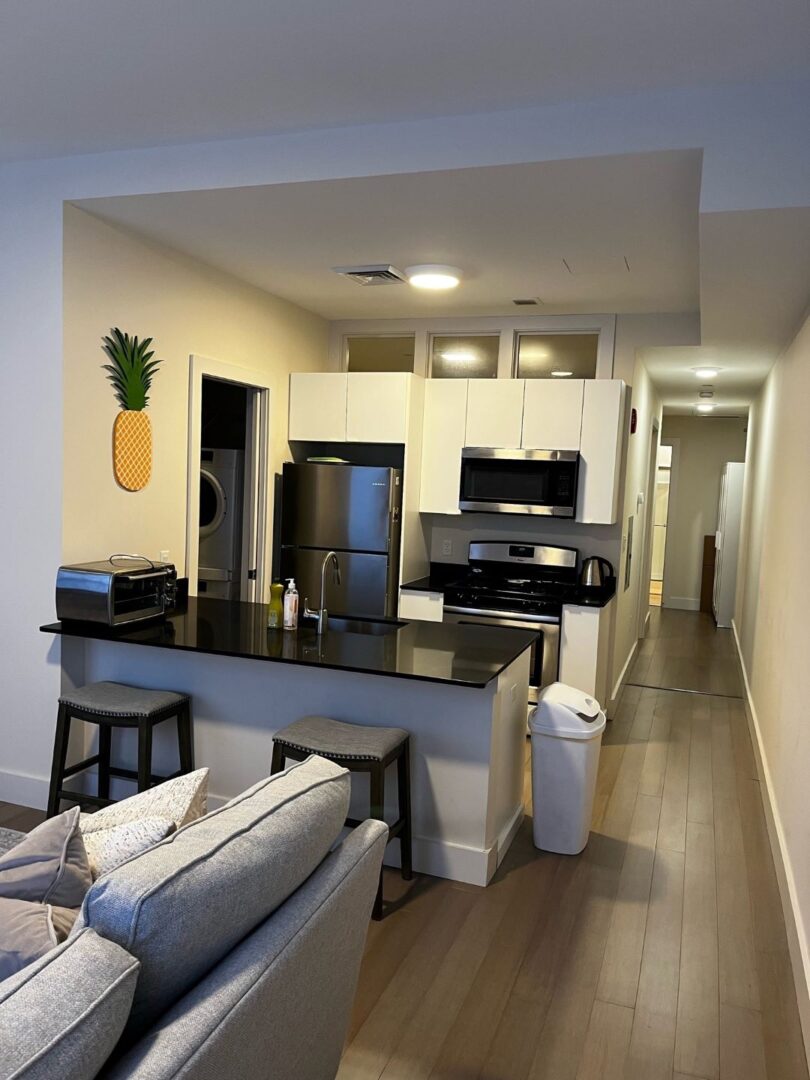 modern kitchen with stainless steel appliances, and wood floors