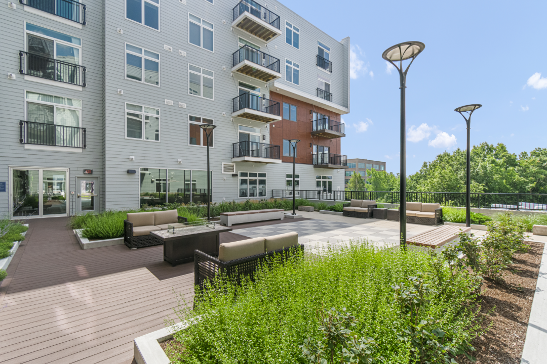 multi-story apartment building with commercial storefront on ground level