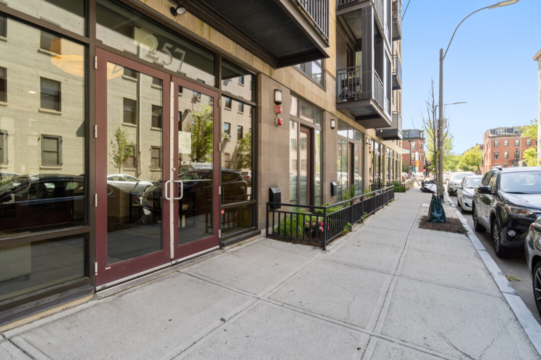 apartment building with commercial storefront on ground level