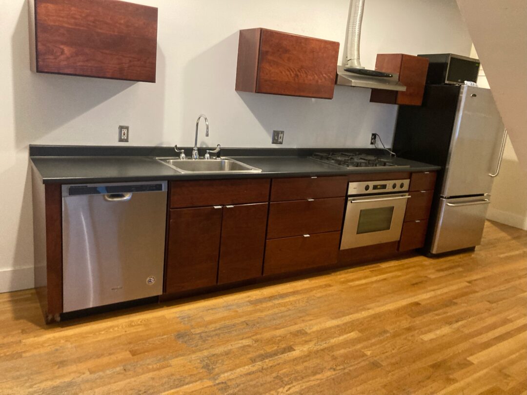 Open layout with a modern kitchen and hardwood floors