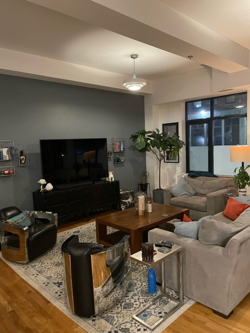 open layout living space with hard wood floors and large picture windows