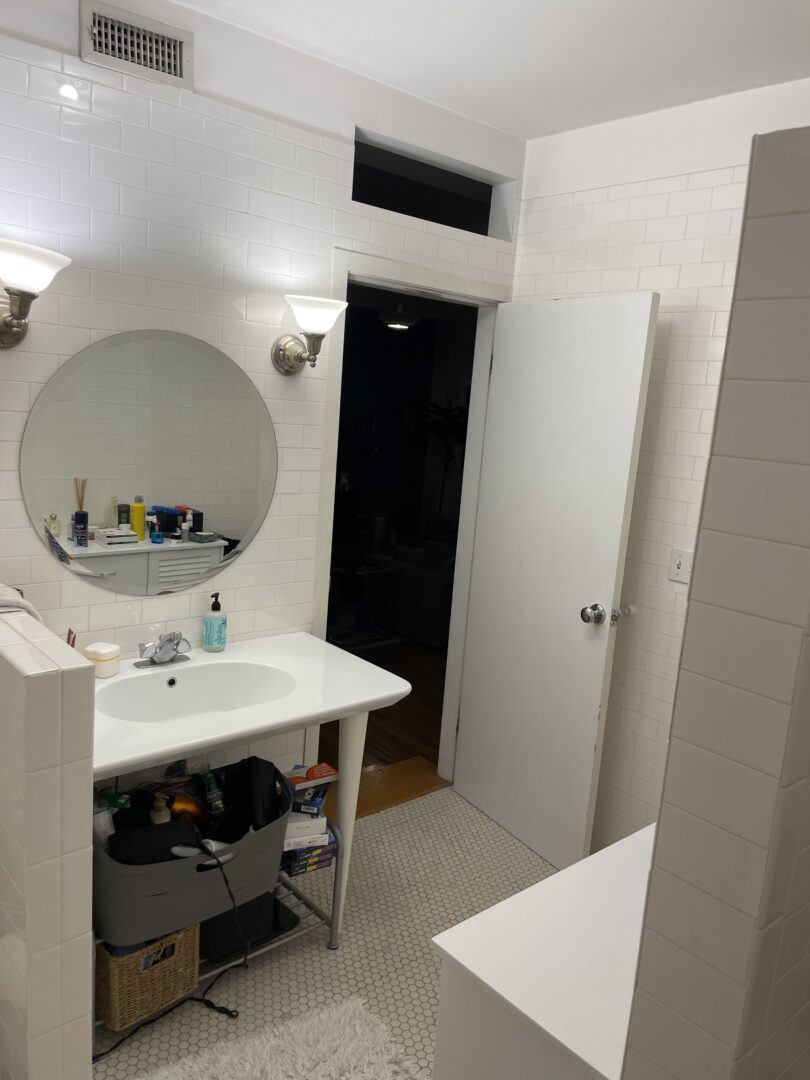 small white bathroom with tile and vanity/mirror