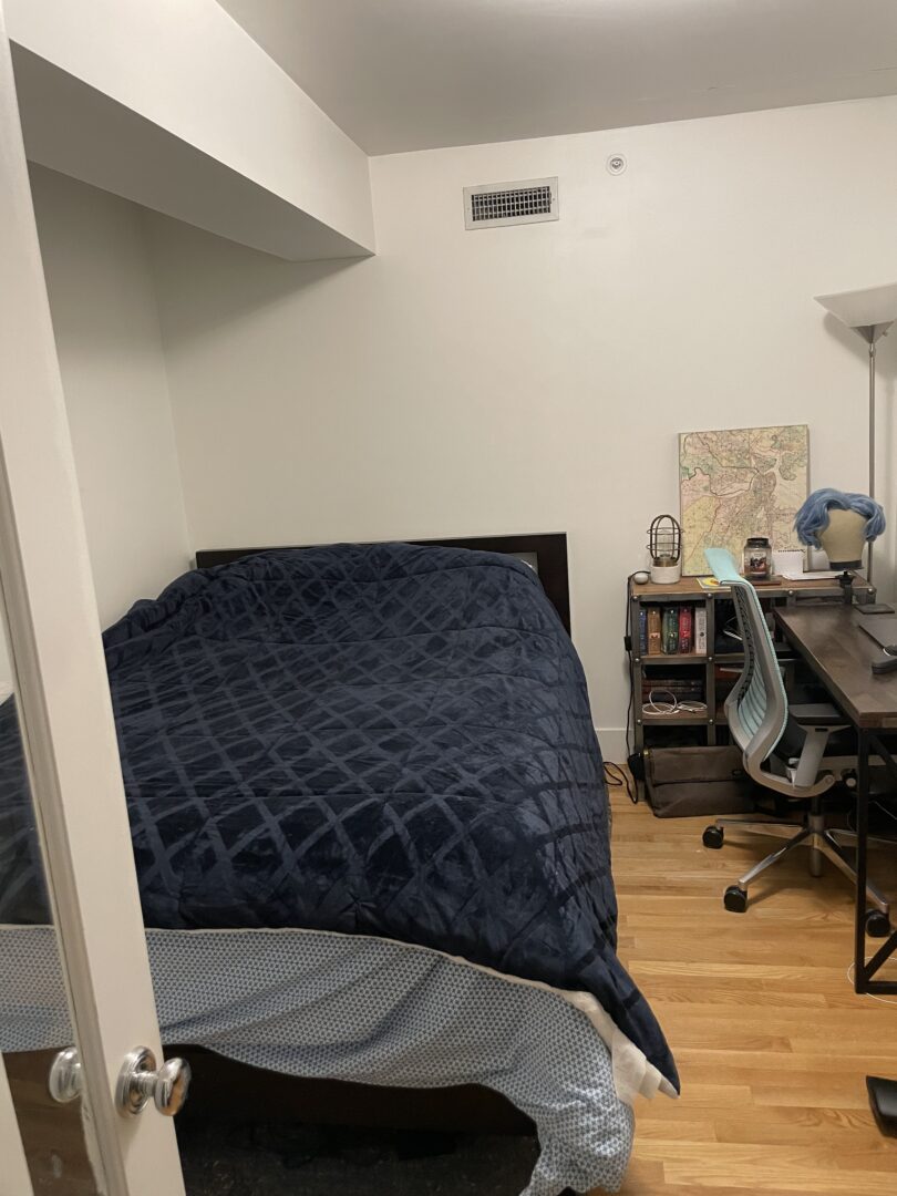 small beige bedroom with hardwood floors