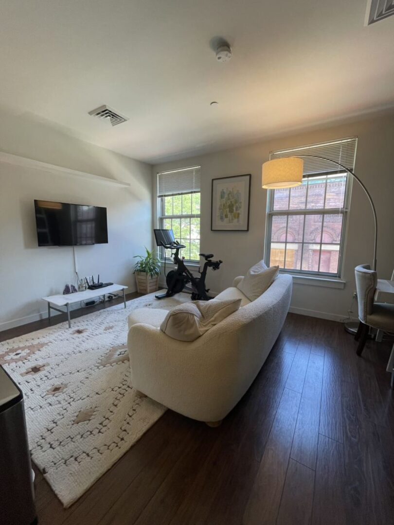 open concept living space with dark wood floors and windows