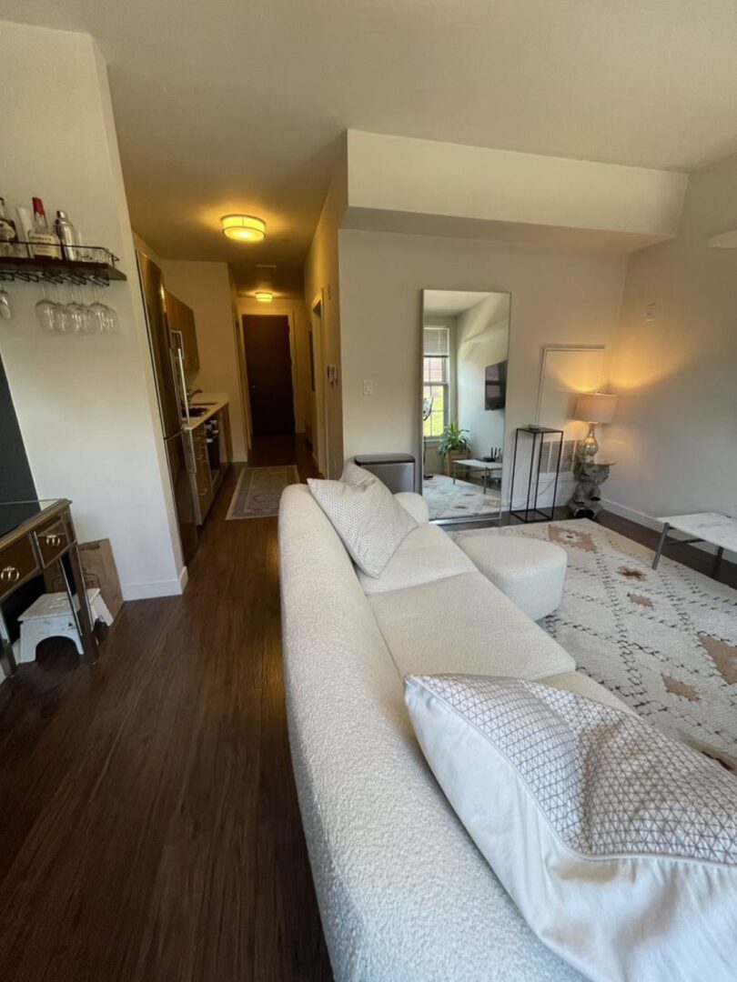 open concept living space with dark wood floors and windows