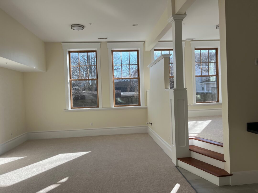 Living room with stairs leading to a foyer