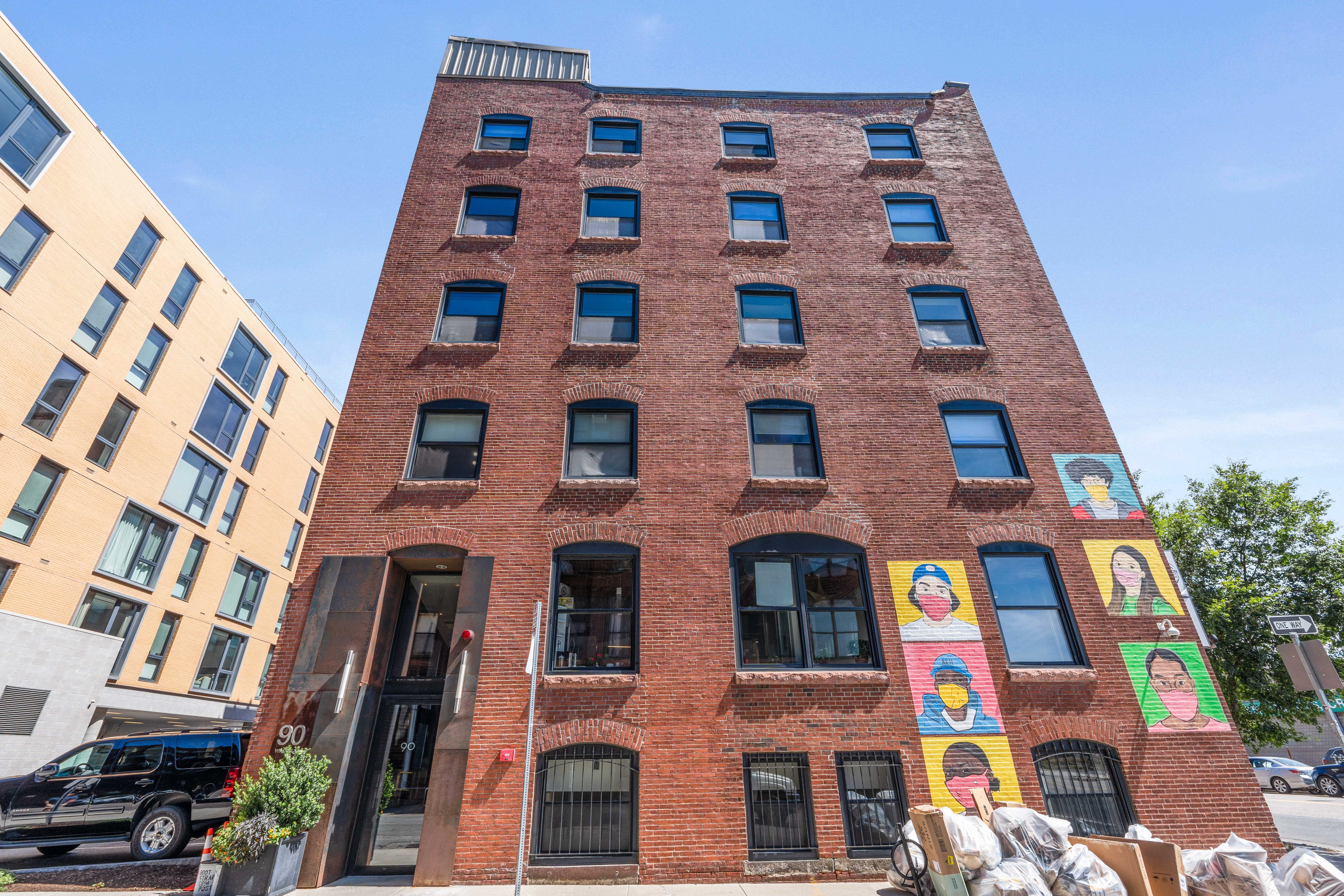 multi-story apartment building with brick exterior and large windows